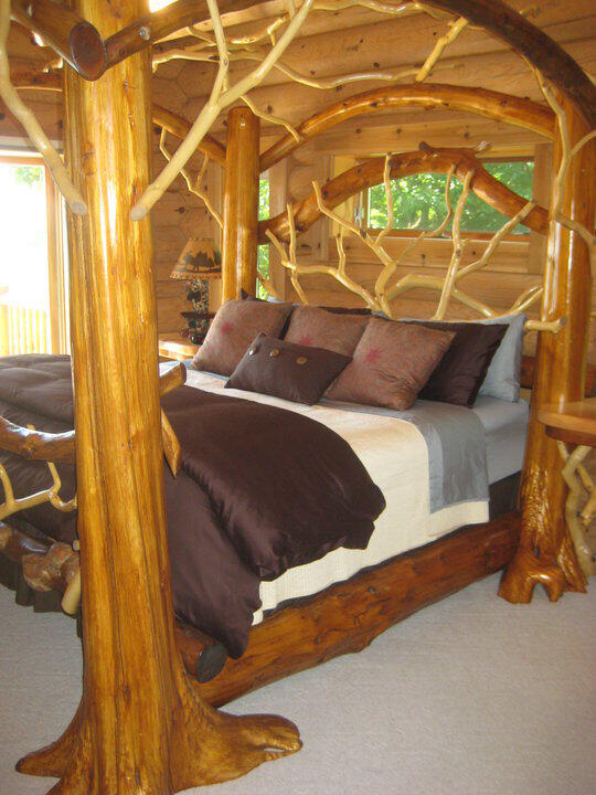 bedroom with log walls and carpet