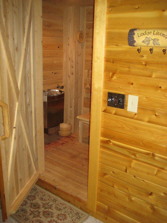 hallway with wood finished floors, wood walls, and a sauna