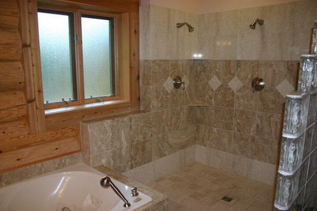 full bath with a tile shower and a whirlpool tub