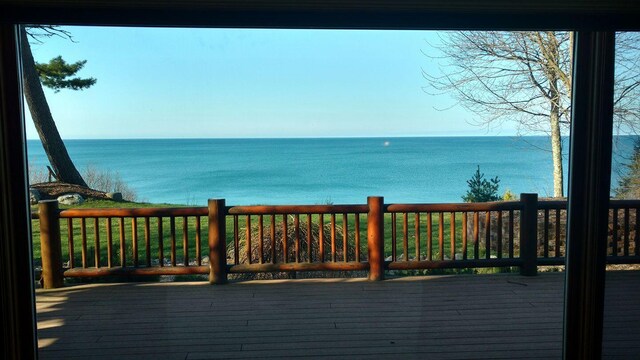 wooden terrace featuring a water view