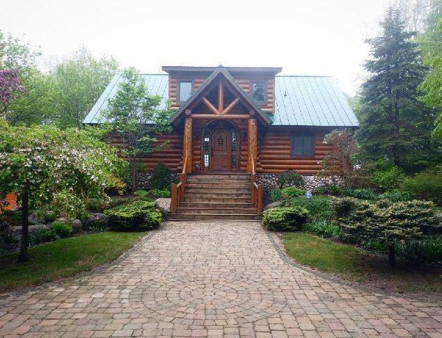 log home featuring log exterior and metal roof