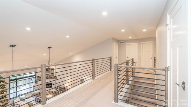 hallway with lofted ceiling