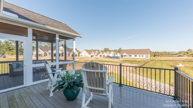 wooden deck featuring a sunroom