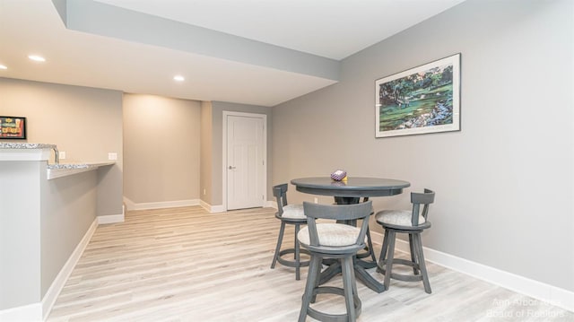 dining space with light hardwood / wood-style floors