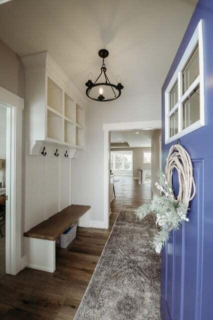 mudroom with dark hardwood / wood-style floors and a chandelier