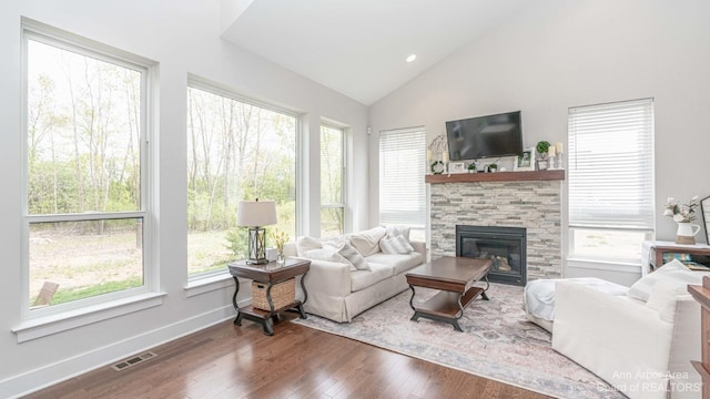 living room with hardwood / wood-style flooring, a fireplace, and vaulted ceiling