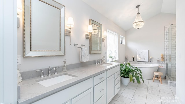 bathroom featuring vanity, a bath, and vaulted ceiling