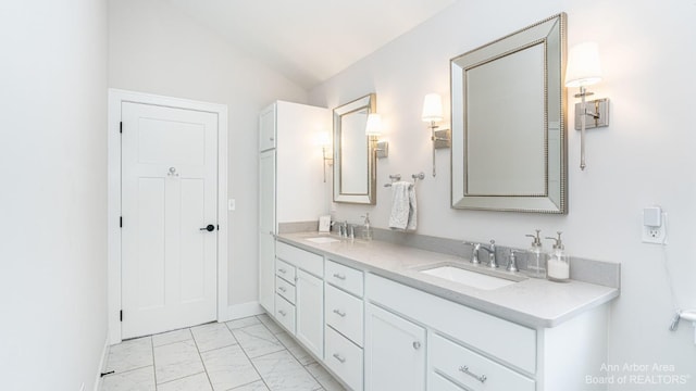 bathroom featuring lofted ceiling and vanity