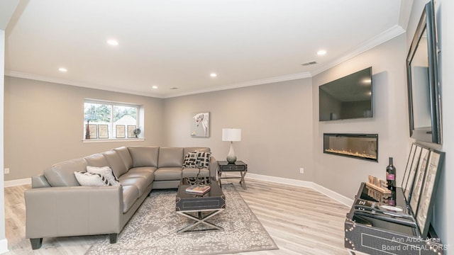 living room featuring ornamental molding and light wood-type flooring