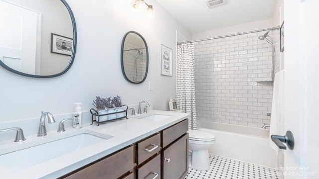 full bathroom featuring vanity, toilet, tile patterned flooring, and shower / bath combo with shower curtain