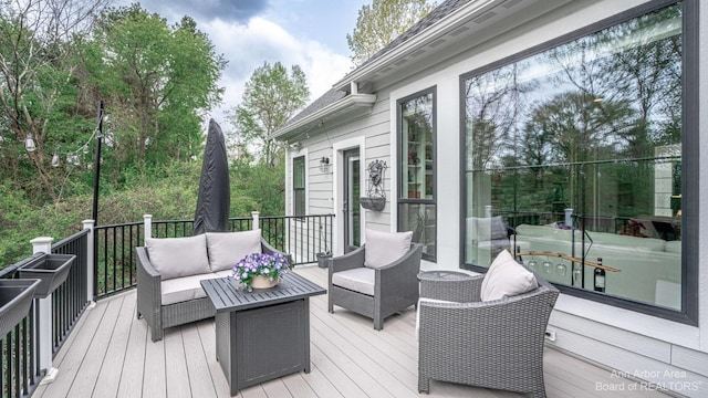 wooden deck with an outdoor living space