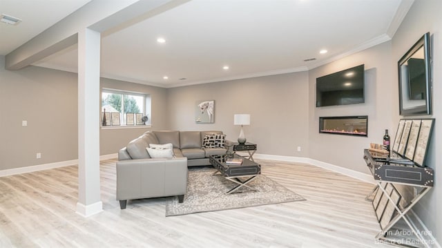 living room with crown molding and light hardwood / wood-style floors