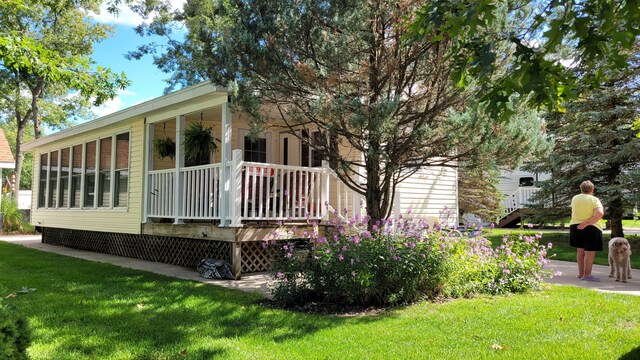 view of property exterior with a lawn