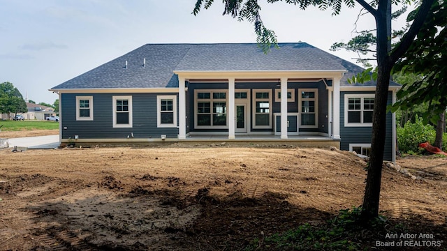 back of house featuring a porch