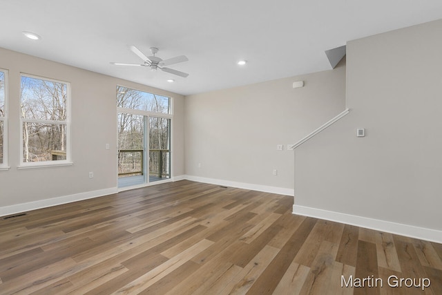 unfurnished room with ceiling fan and dark wood-type flooring