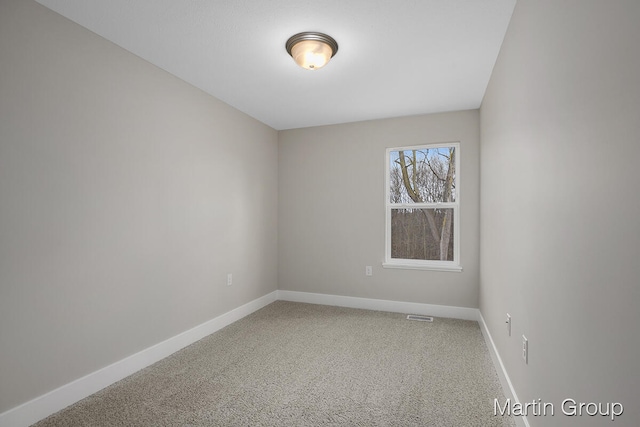 unfurnished room featuring light colored carpet