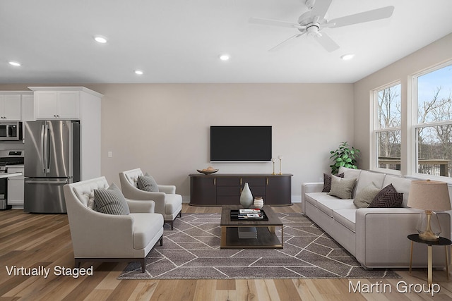 living room featuring dark hardwood / wood-style flooring and ceiling fan