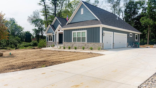 craftsman inspired home with a garage and central air condition unit