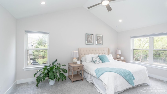 bedroom featuring multiple windows, vaulted ceiling, ceiling fan, and carpet