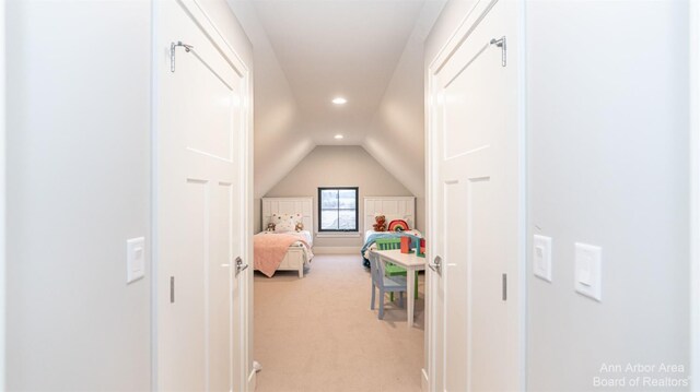 bedroom featuring vaulted ceiling and light colored carpet