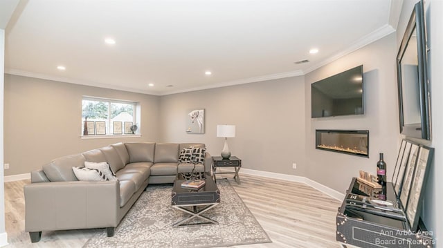 living room with crown molding and light hardwood / wood-style flooring