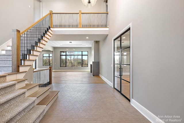 entrance foyer featuring a towering ceiling