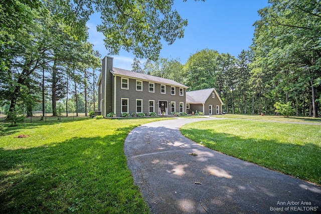 colonial inspired home with a front yard