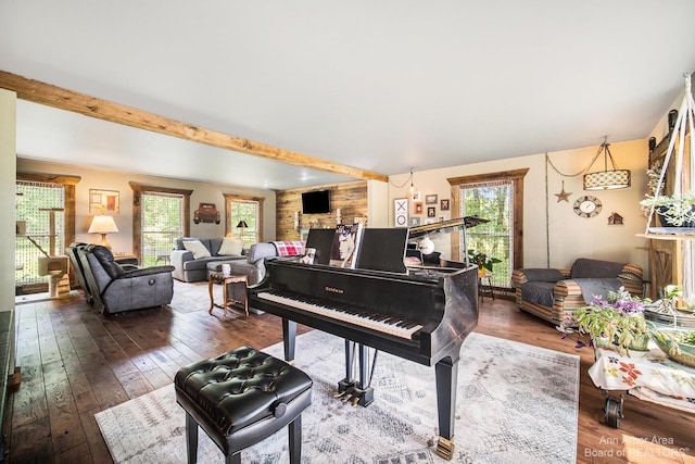 miscellaneous room with dark wood-type flooring and beam ceiling