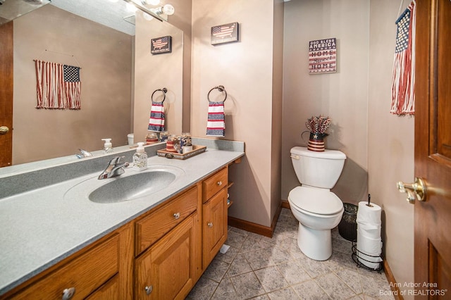 bathroom featuring toilet and vanity