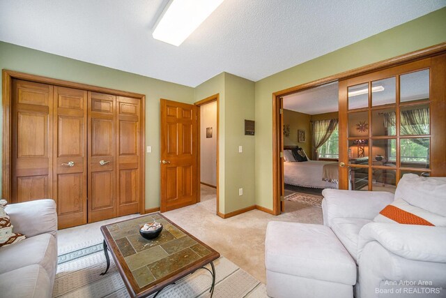 living room with light colored carpet and a textured ceiling