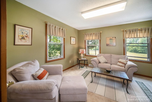 living room featuring light carpet, plenty of natural light, and a textured ceiling