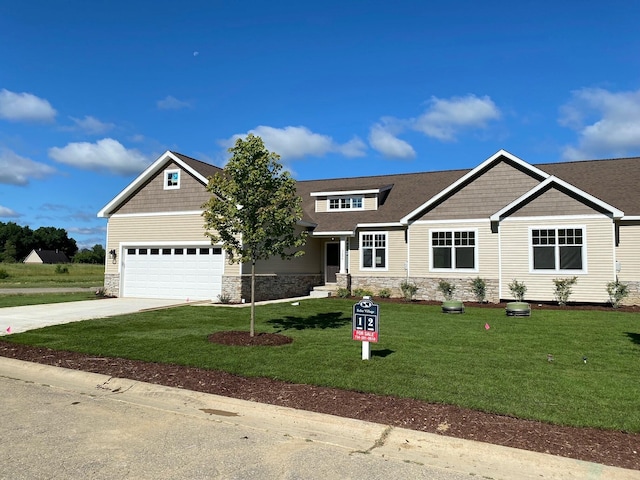 craftsman inspired home with a garage and a front lawn