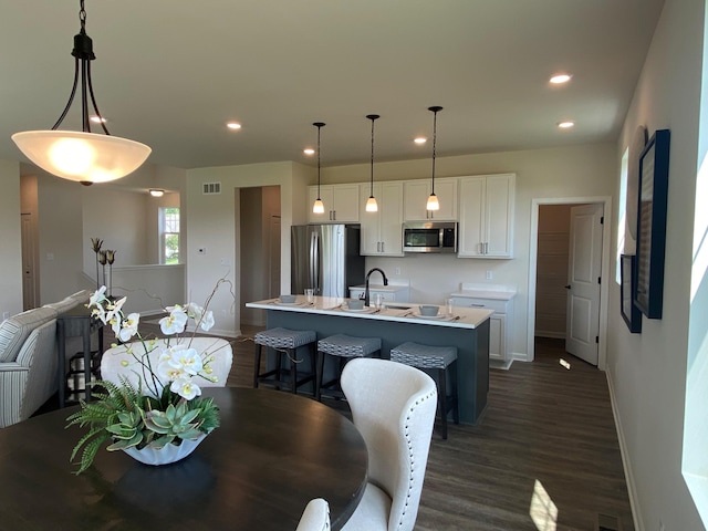 dining area featuring sink and dark hardwood / wood-style flooring