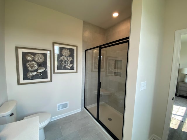 bathroom with walk in shower, toilet, and tile patterned flooring