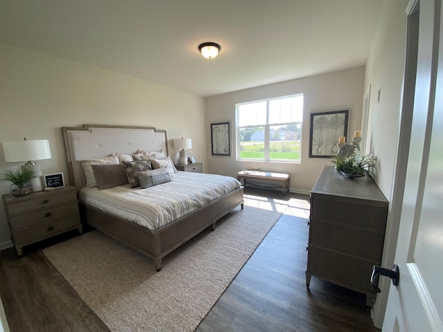 bedroom with dark hardwood / wood-style flooring