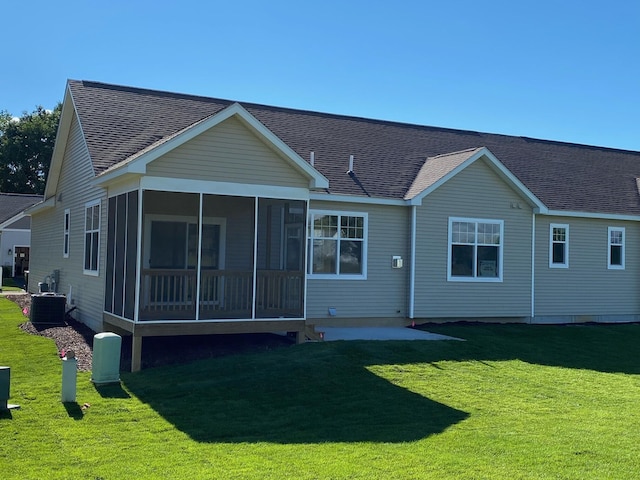 back of house with a yard, central AC unit, and a sunroom