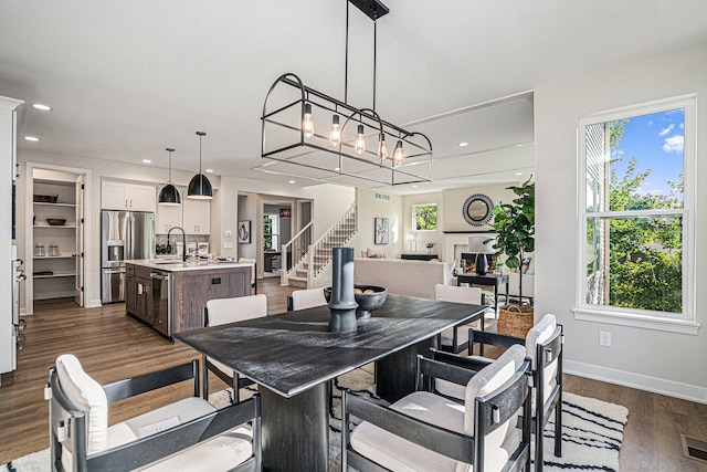 dining room featuring plenty of natural light, sink, and dark hardwood / wood-style floors