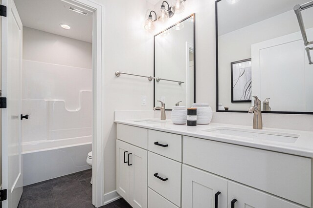 full bathroom featuring shower / tub combination, vanity, tile patterned floors, and toilet