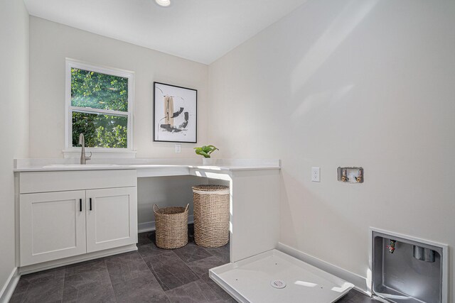 washroom featuring sink and cabinets