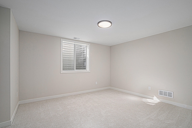 unfurnished room featuring carpet flooring