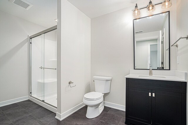 bathroom featuring vanity, tile patterned floors, toilet, and walk in shower