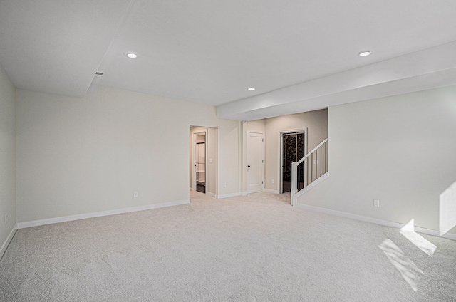 unfurnished room with light colored carpet