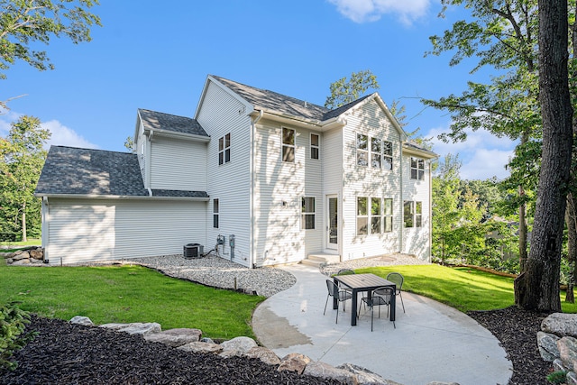 back of house with a patio, central air condition unit, and a lawn