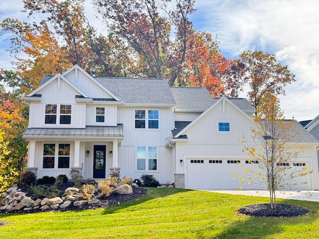 view of front of property featuring a garage and a front yard