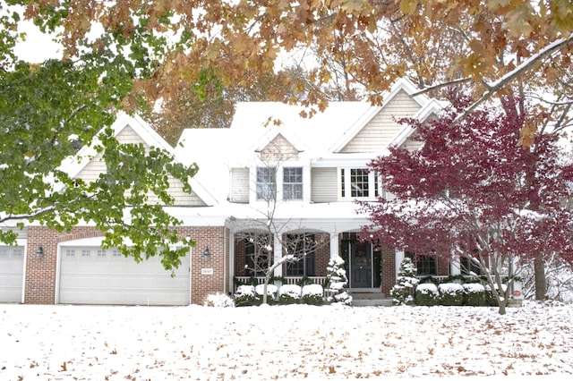 view of front of home featuring a porch and a garage