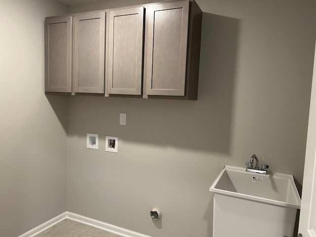 washroom featuring cabinets, sink, and hookup for a washing machine