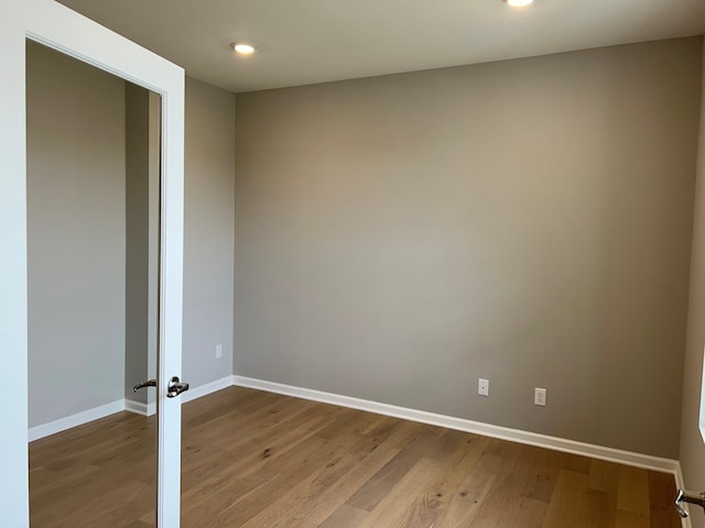 spare room with hardwood / wood-style flooring