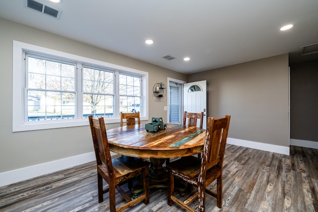 dining space with dark hardwood / wood-style flooring