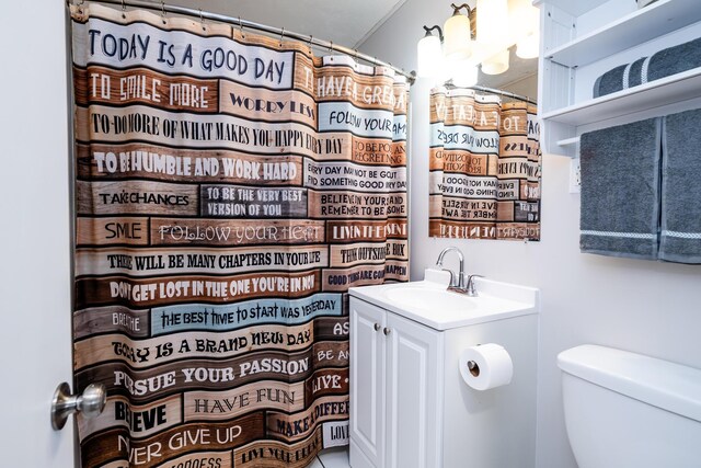 bathroom featuring toilet, a notable chandelier, and vanity