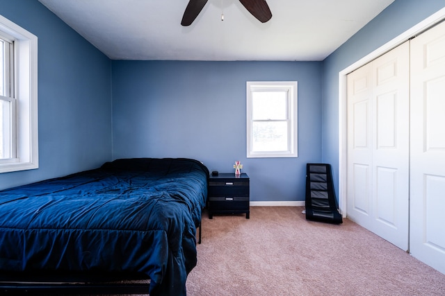 bedroom featuring a closet, ceiling fan, and carpet flooring